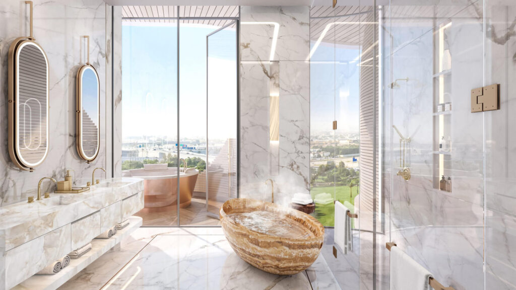 Master bathroom at One Canal Dubai with marble finishes, freestanding stone bathtub, double vanity, and skyline view