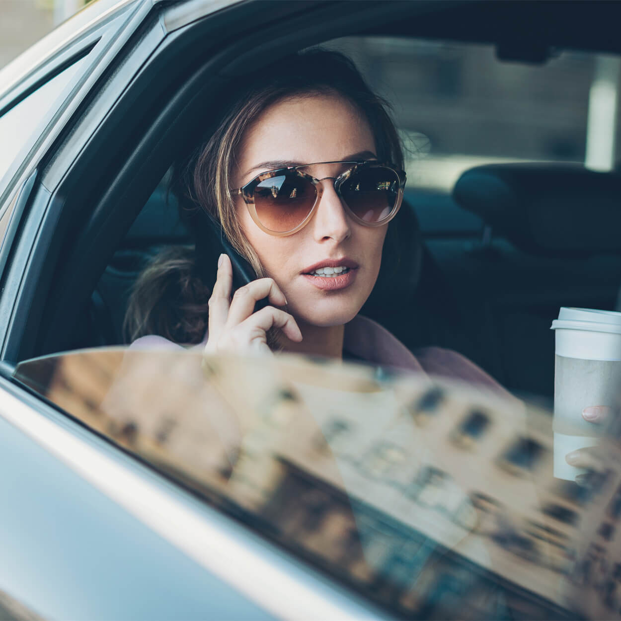 VIP woman in luxury car speaking on phone in Dubai